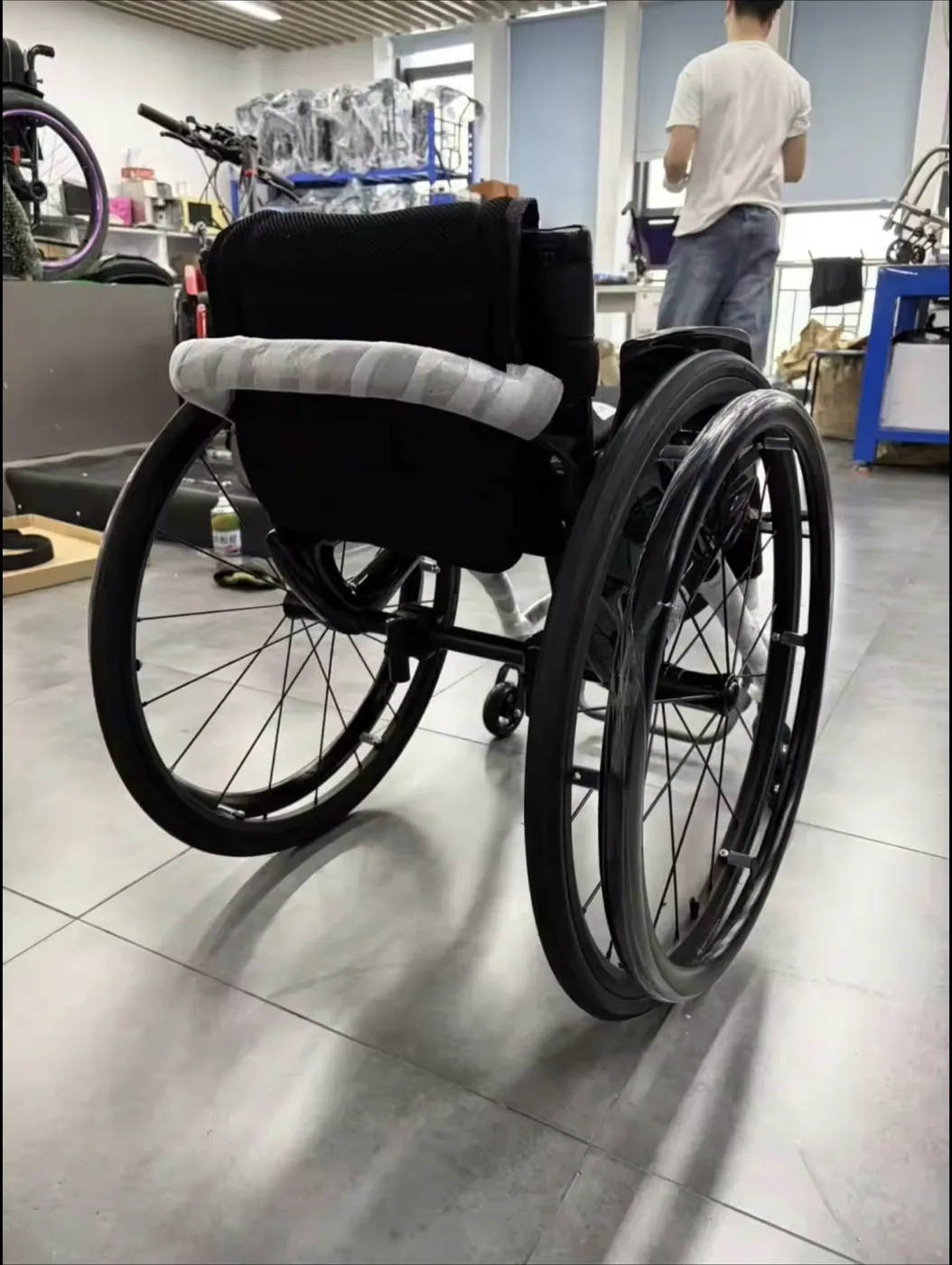 Manual carbon fibre wheelchair rear view with 24-inch quick-release wheels