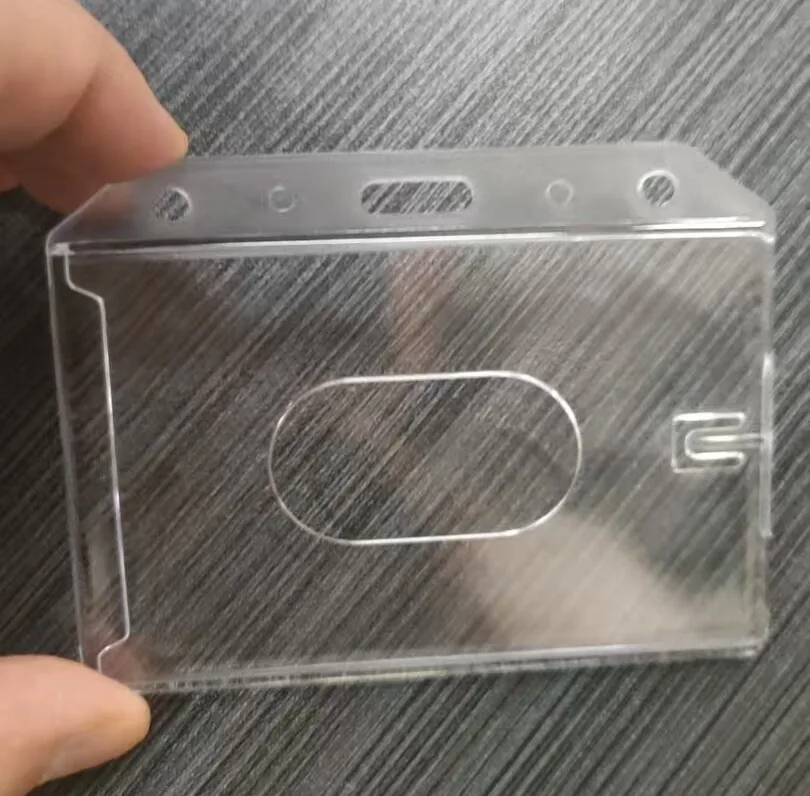 Rigid ID card holder, top edge showing lanyard slots