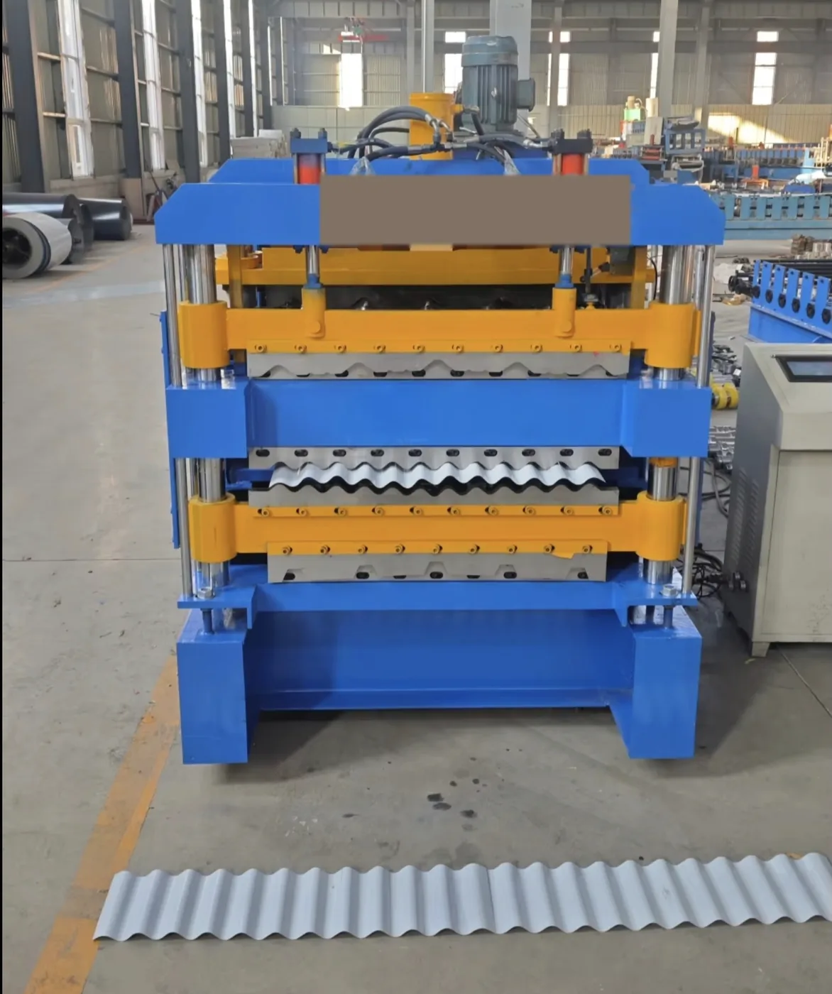 Corrugated roof sheet coming off the three forming decks of the roll forming machine